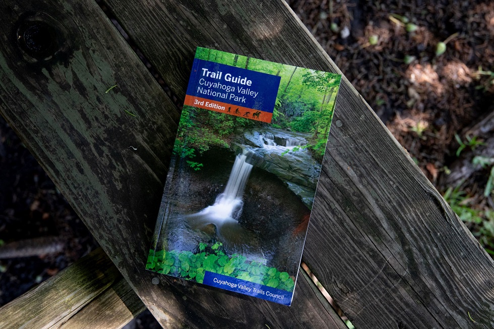 A trail guide of CVNP sits on a picnic bench.