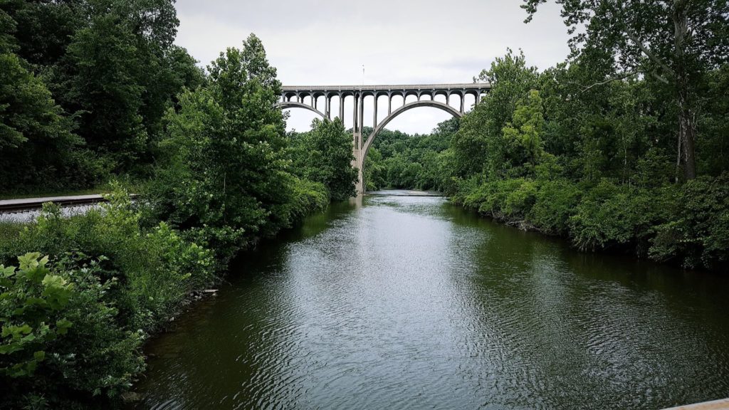 A bridge over the Cuyahoga River surrounded by trees in CVNP.