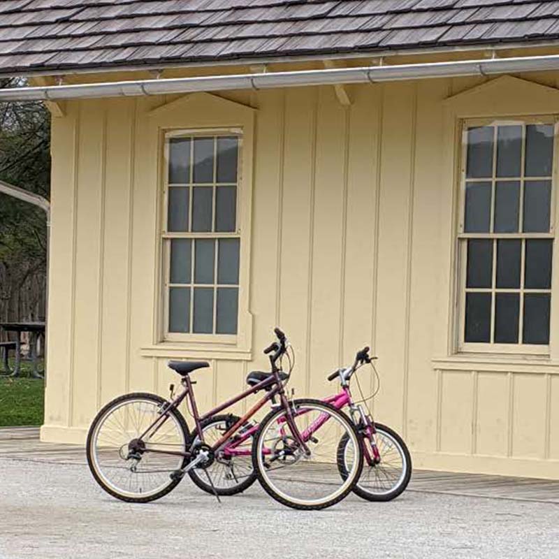 two bikes leaning against train depot