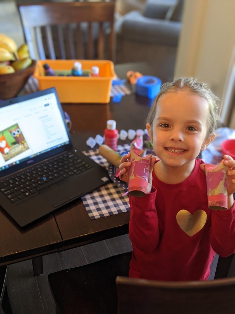 Girl holding the DIY toilet paper owls she made