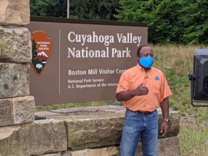 Fox 8's Kenny Crumpton does a live shot at the Cuyahoga Valley National Park Sign