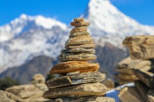 A Rock Cairn with mountains (stacked rocks) in the background