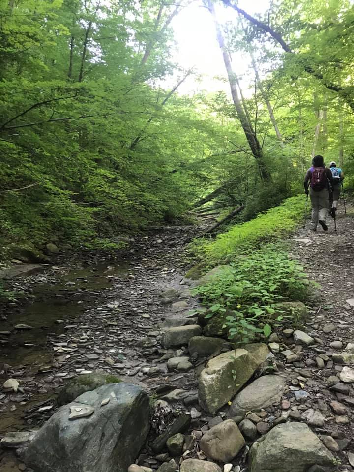 Group hiking along rocky path in CVNP