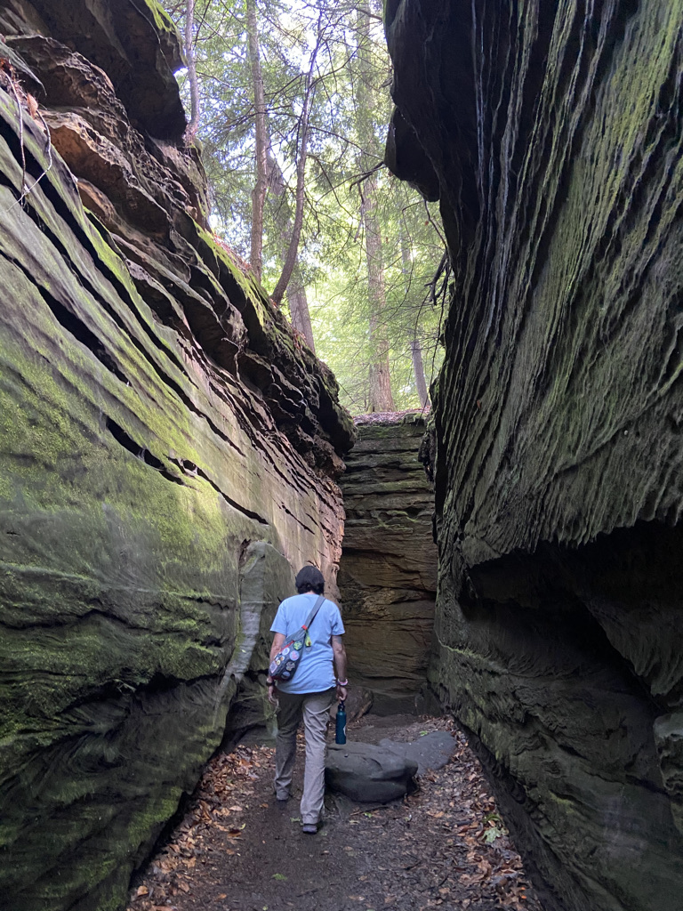 Person walking through cliffs at Ledges Trail