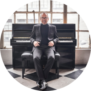 Brian Simpson sitting at piano