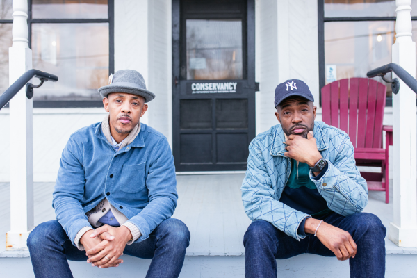 Michael Russell II on left and Antwoine Washington on right sitting on the steps of the gallery.