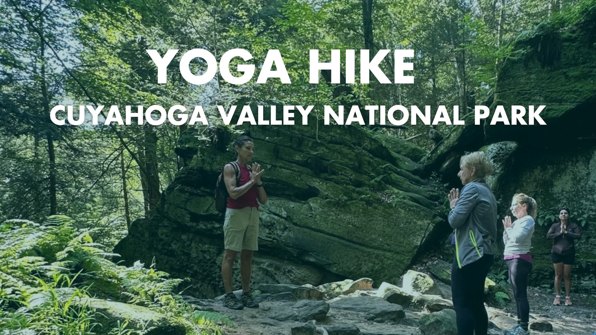 Group doing yoga pose among rocks at Ledges.