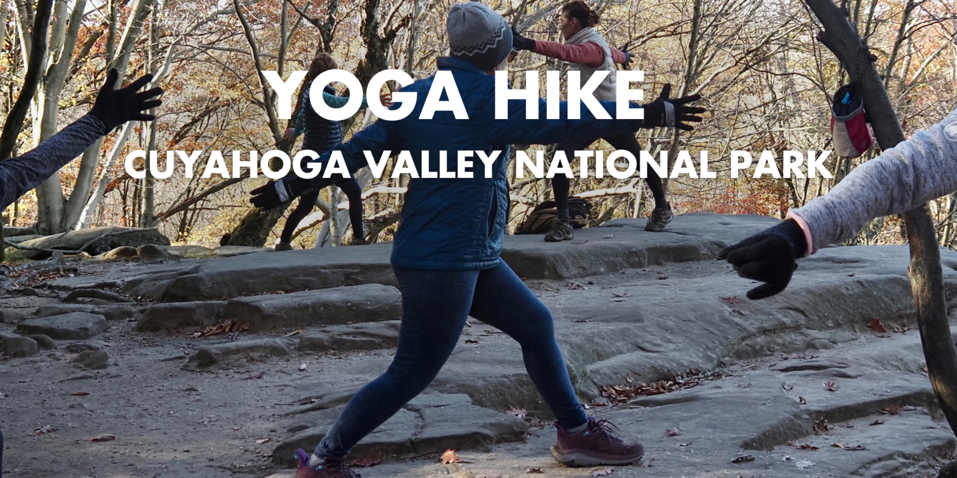 A group of people do a yoga pose at the Ledges.