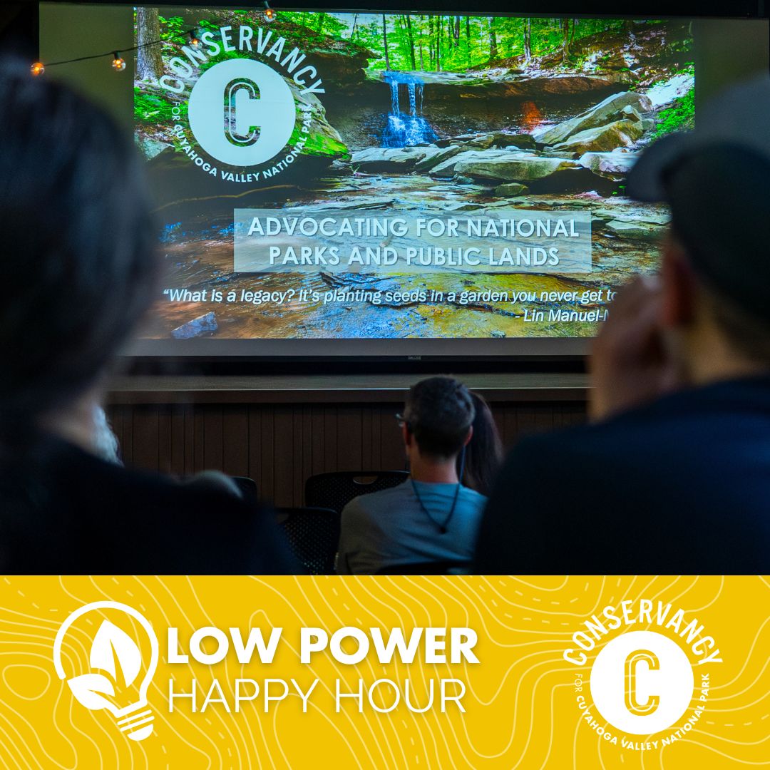 A graphic for Low Power Happy Hour that includes an audience shot and a large screen within Happy Days Lodge in Cuyahoga Valley National Park.